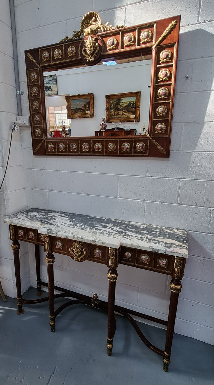 Vintage Mahogany marble top console table with matching mirror. Both with inset limoge panels surrounded by gilt brass. Highly decorative and in good original detailed condition. Circa 1950.