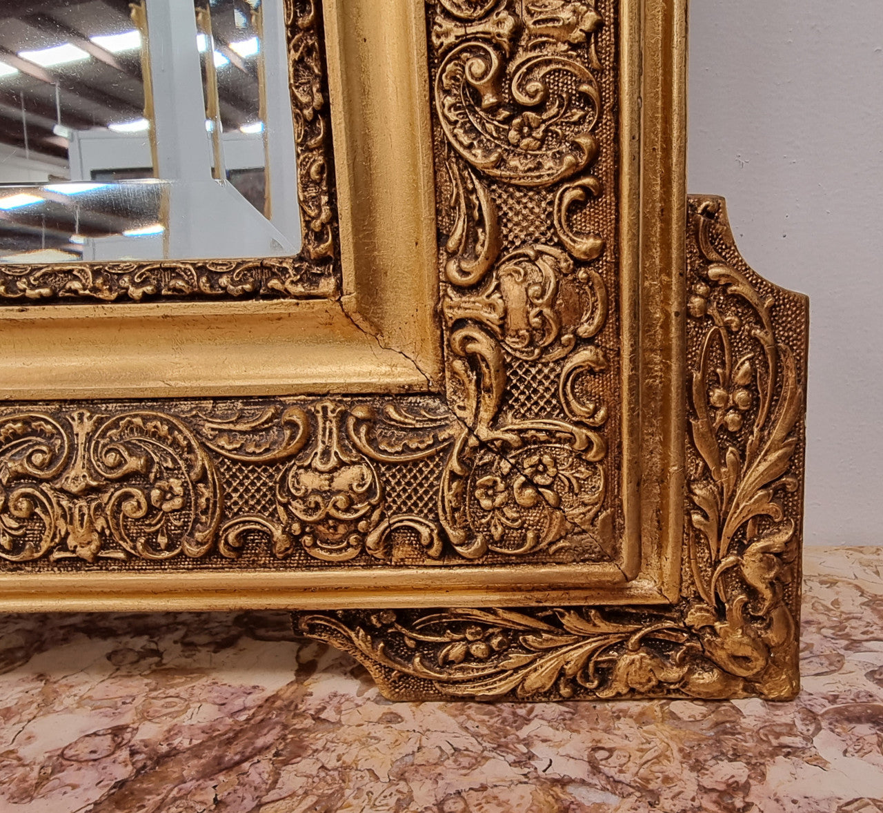 French ornate gilt decorated and floral bevelled mirror. It has been sourced from France and it is in good original condition.