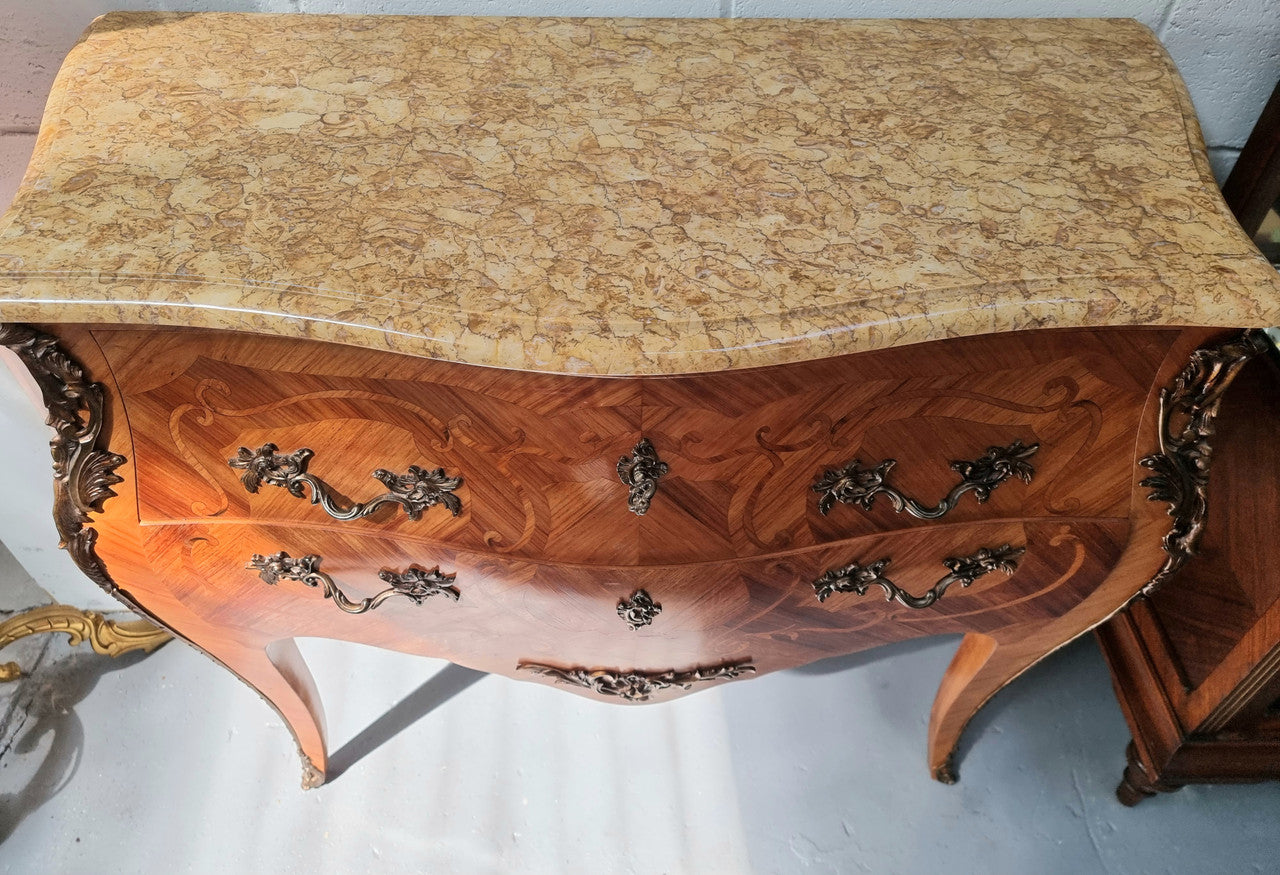 French marquetry inlaid Kingwood marble top commode. It has two drawers and beautiful mounts. Is in good original detailed condition.