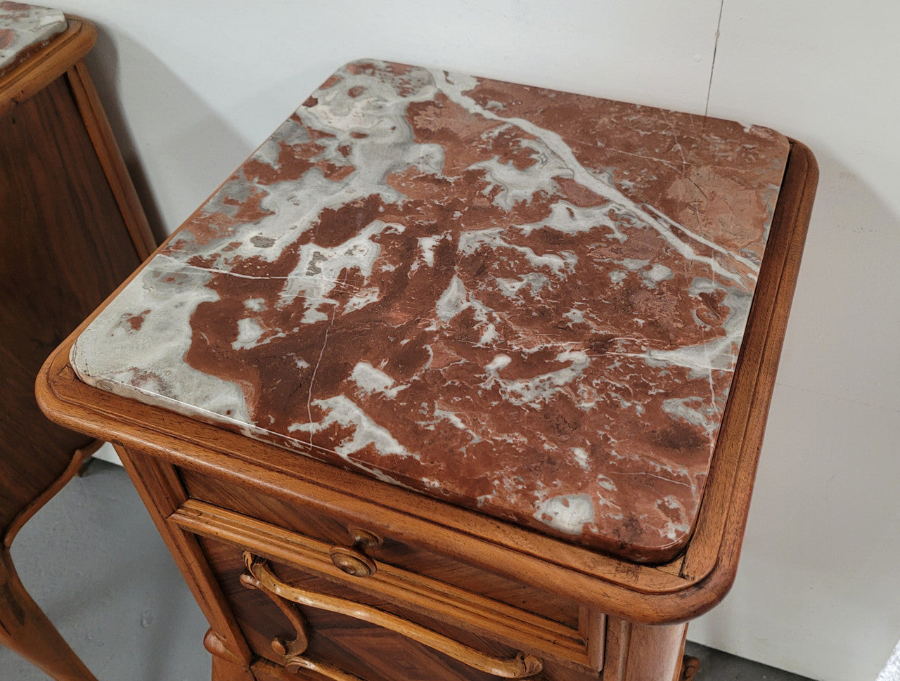 Pair French Walnut Louis XV style Bedside Cabinets with inset rouge carrera marble tops and parquetry inlay. Consisting of one drawer and one cupboard on very elegant legs. Circa: 1900's.