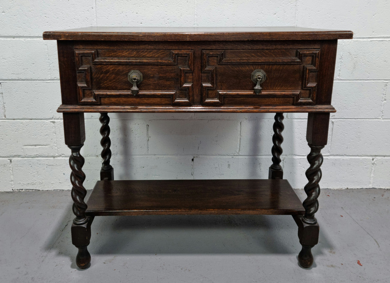 Lovely dark oak small Jacobean style two drawer side cabinet with barly twist legs and lovely carved details. In good original detailed condition.