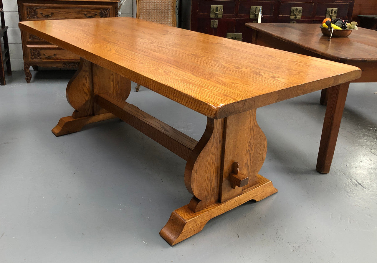 A French Style Oak stretcher base table with amazing wood grain. Can comfortable sit 6-8 people and is in original detailed condition.