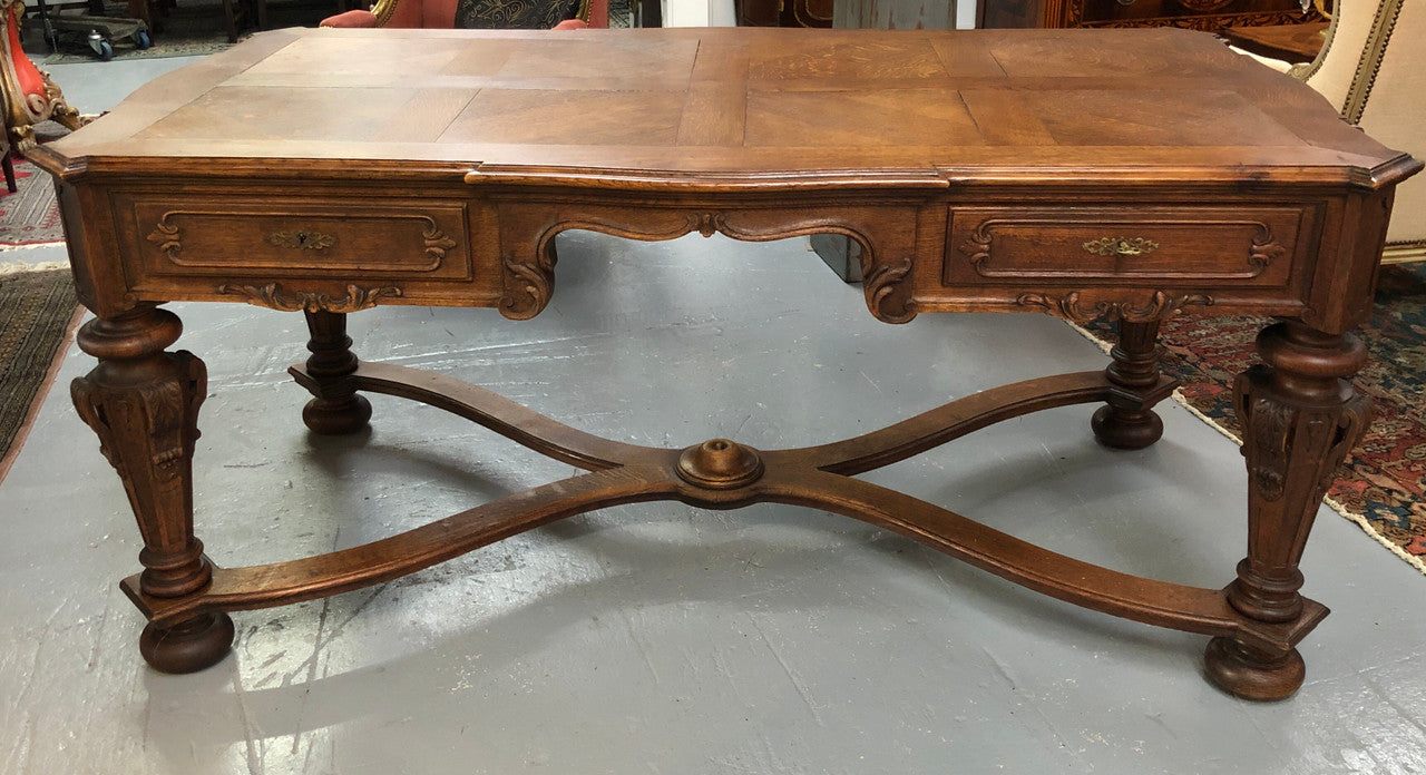Beautifully carved 19th century French oak Bureau Plat. With a lovely parquetry top and two drawers and decorative carved legs this piece is definitely one to look at . In good original detailed condition.