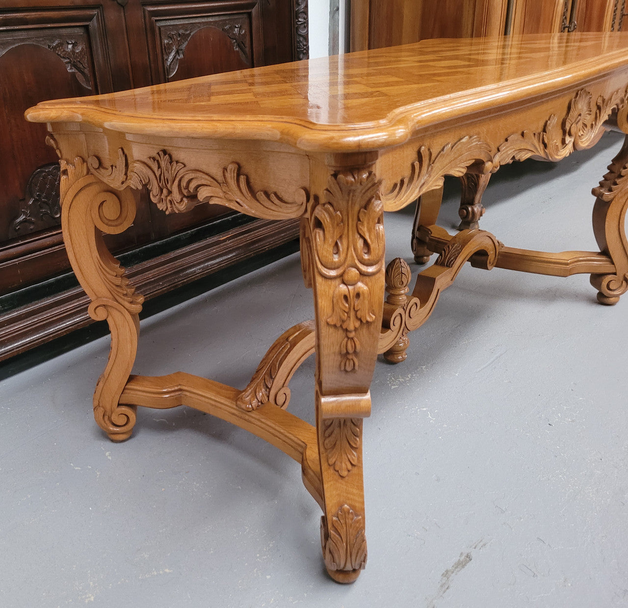 French Oak parquetry top coffee table with decorative carved base. It is in good original detailed condition.