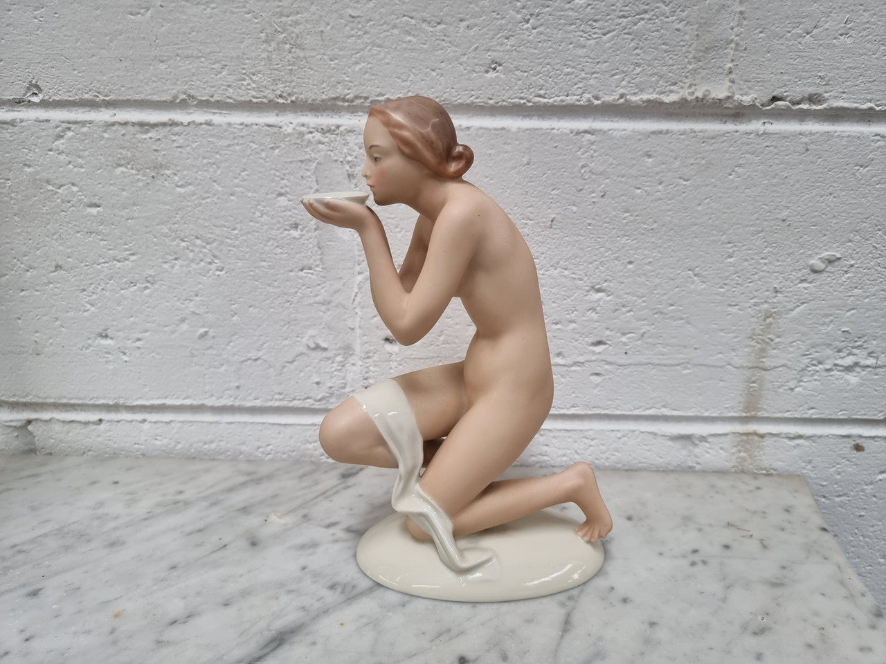Elegant Art Deco kneeling nude female figurine by "Pirken Hammer". Circa 1918-1938.