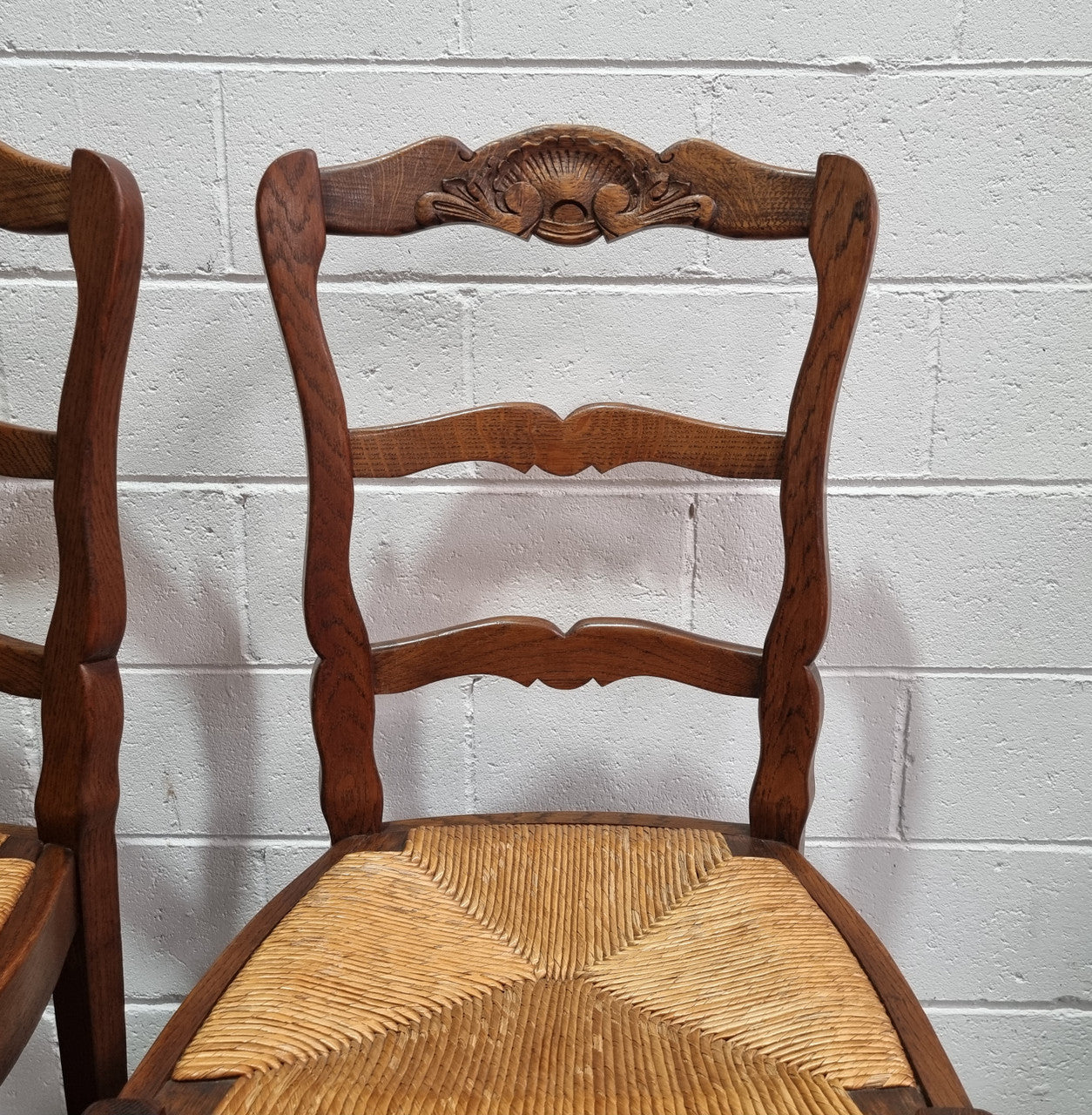 Lovely set of six French oak rush seated provincial dining chairs. They have been sourced from France and are in good detailed condition.