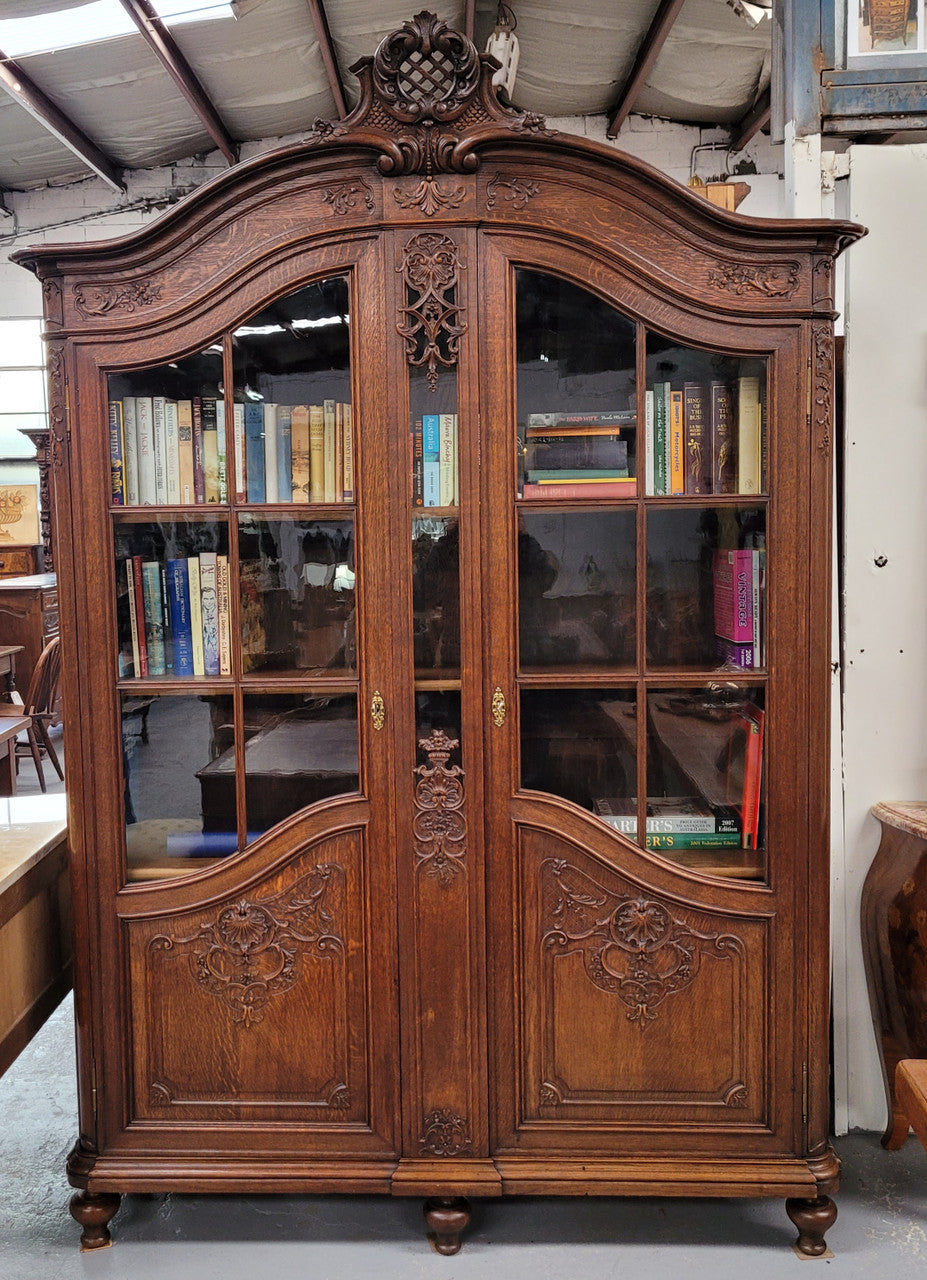 Substantial French Oak Louis 15th Style large two door bookcase. Adjustable shelves and very decorative carving. In good original detailed condition.