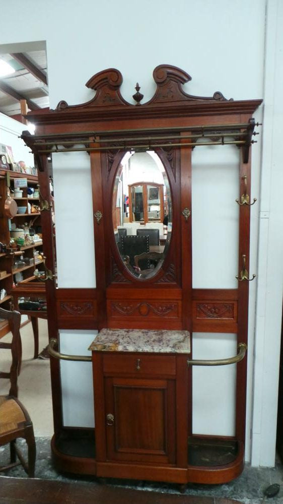 French mahogany hall stand with a marble top drawer. It has beautiful large brass hooks and fittings. It is in very good original detailed condition.