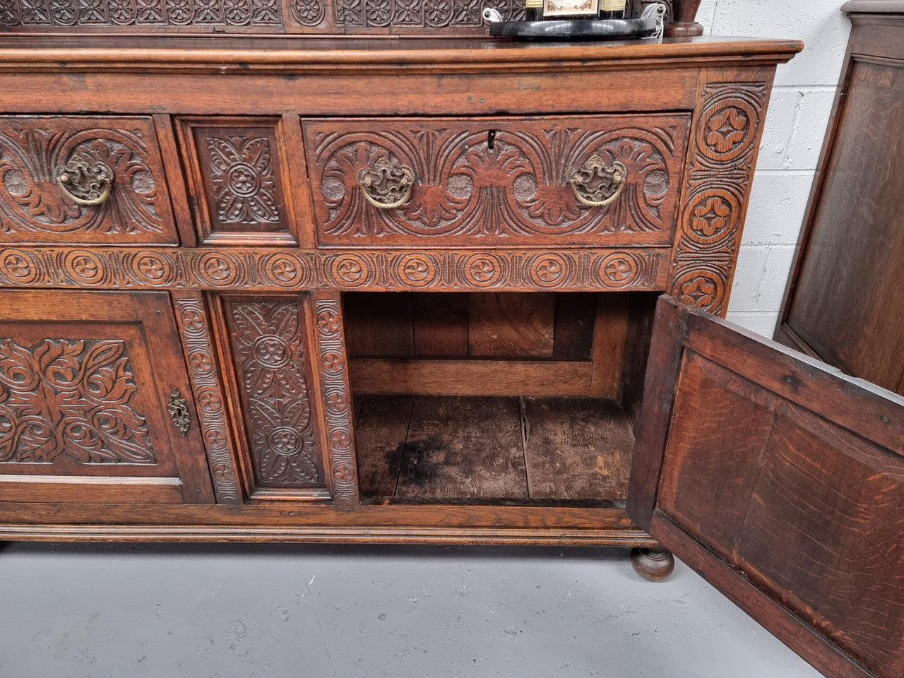 Impressively carved 18th Century English Oak kitchen dresser in 17th Century Jacobean style. It is in good original detailed condition and has been sourced from France.
