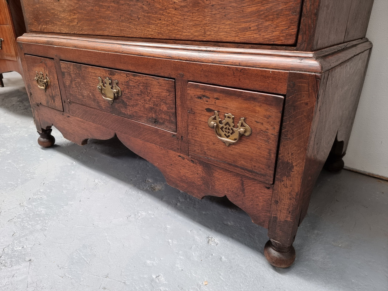 Early 19th Century English Oak chest on stand. It has been sourced in France and has plenty of storage space with eight drawers. In good original detailed condition.