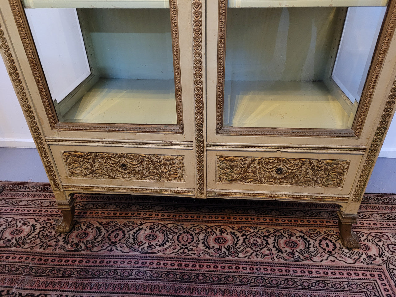 19th Century painted and gilt two door vitrine. Has one adjustable shelf and two drawers. In good original detailed condition.