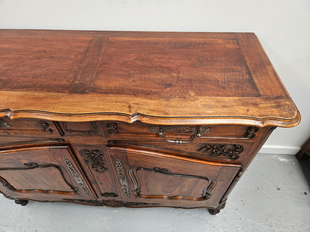 Attractive French Walnut Louis XV style two door two drawer sideboard featuring beautiful carving. Circa: 1930's. It has been sourced from France and it is in good original detailed condition.