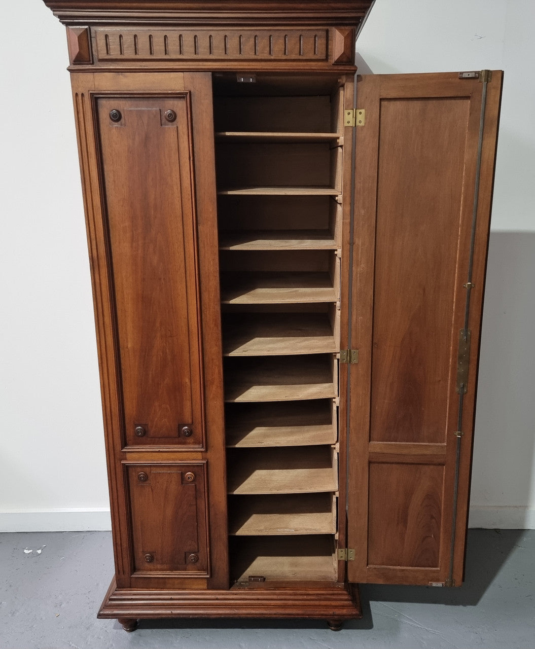 French Henry II style Walnut linen storage cupboard with nine pull out shelves. This piece could be very functional for a range of different purposes including shoe storage. It is in good original detailed condition, please note the door lock no longer functions and opens by pulling the door.