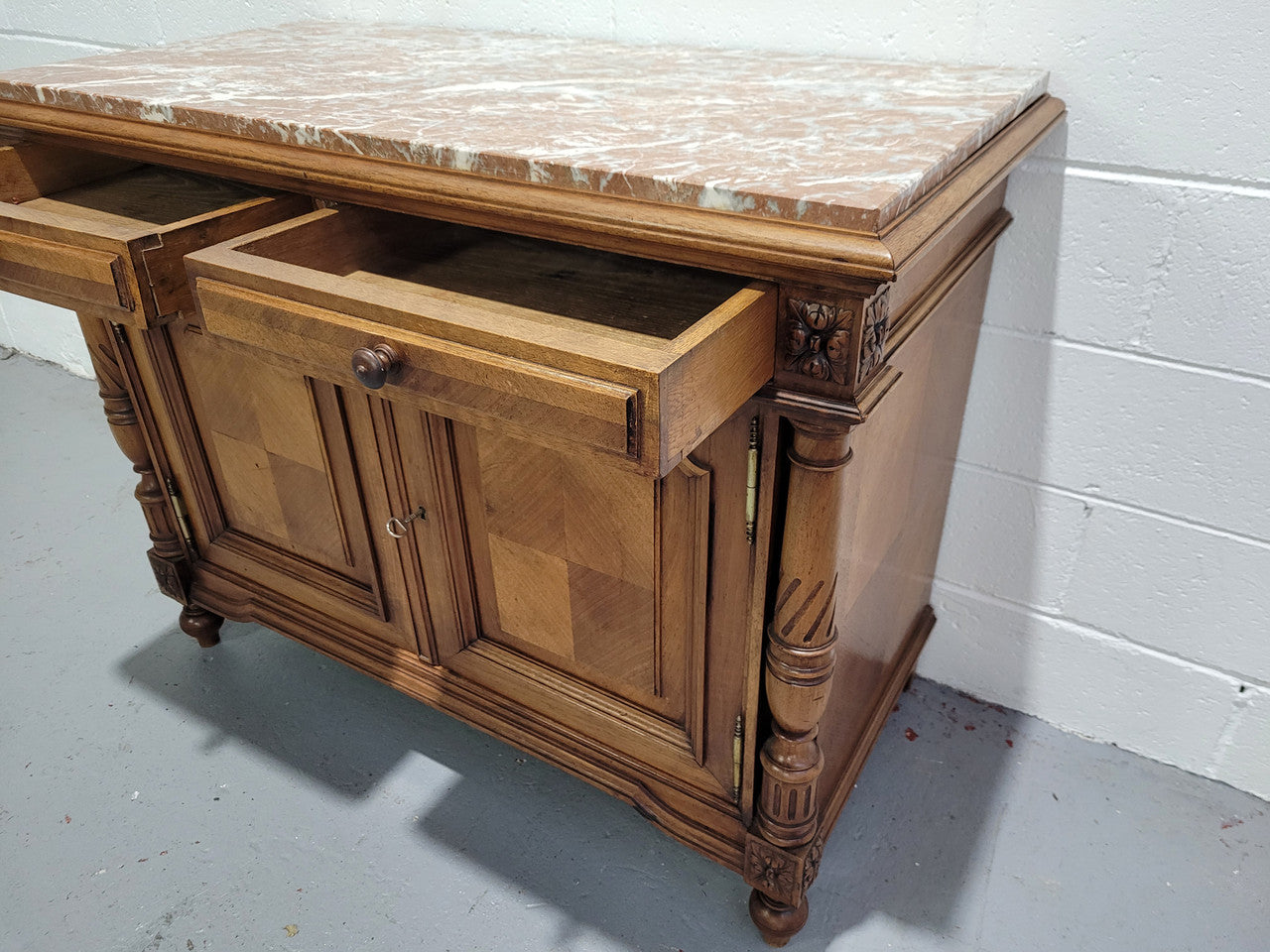 Stunning French walnut Henry II style marble top side cabinet with two drawers and two shelves inside. In good original detailed condition.