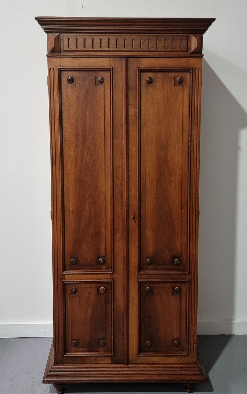 French Henry II style Walnut linen storage cupboard with nine pull out shelves. This piece could be very functional for a range of different purposes including shoe storage. It is in good original detailed condition, please note the door lock no longer functions and opens by pulling the door.