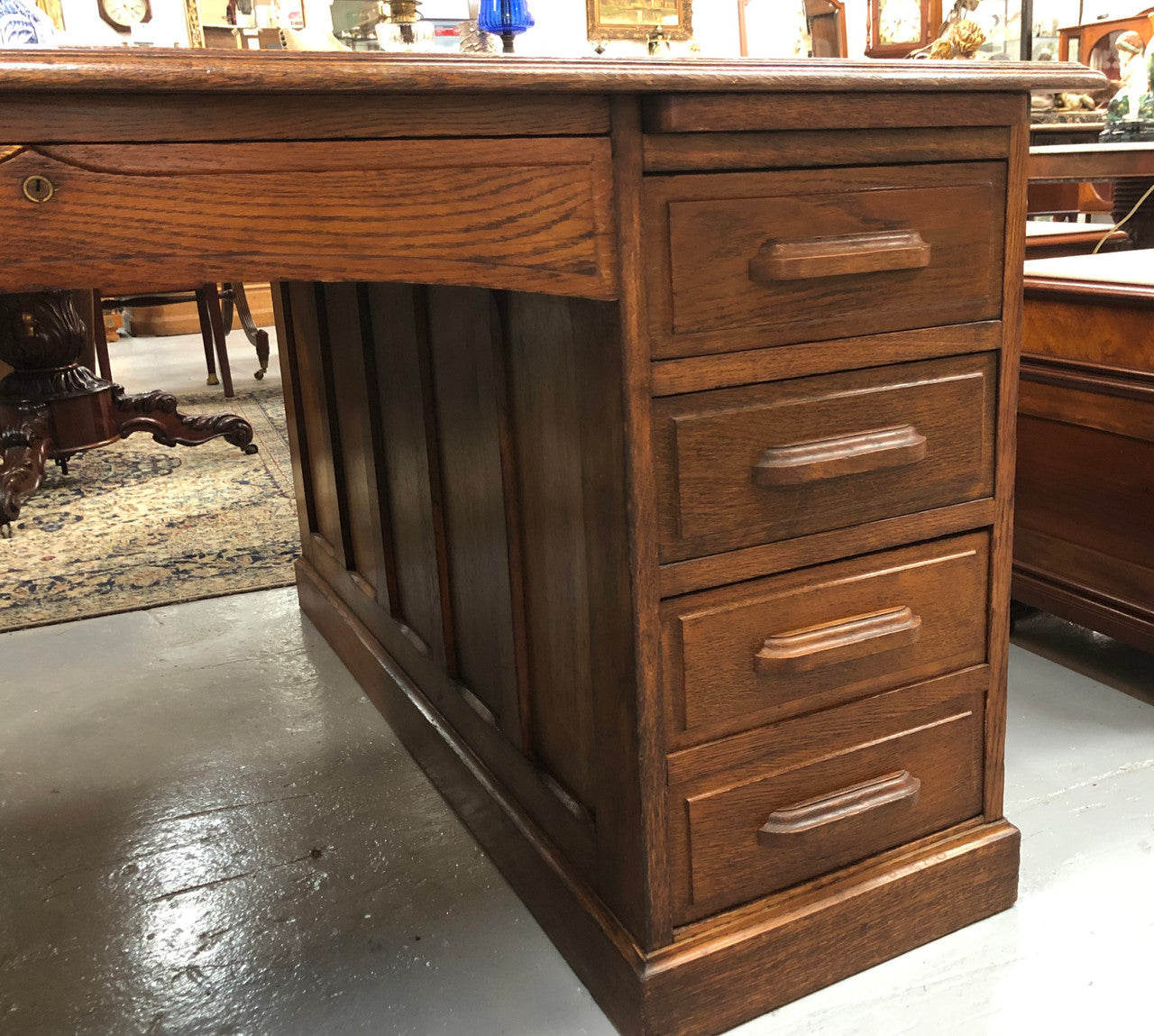 Lovely large English oak partners desk, with a beautiful burgundy tooled leather top. Plenty of storage space, both sides have 9 functioning drawers. It is in very good condition.