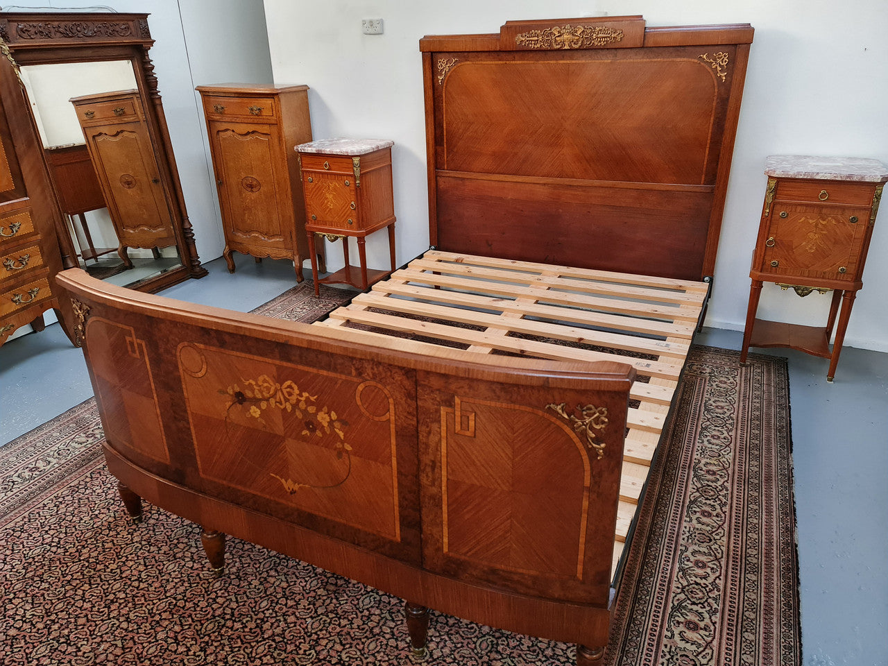 A high quality French Louis XV style bow fronted Queen size bed with marquetry inlay and ormolu mounts. In good original detailed condition. Circa: 1920