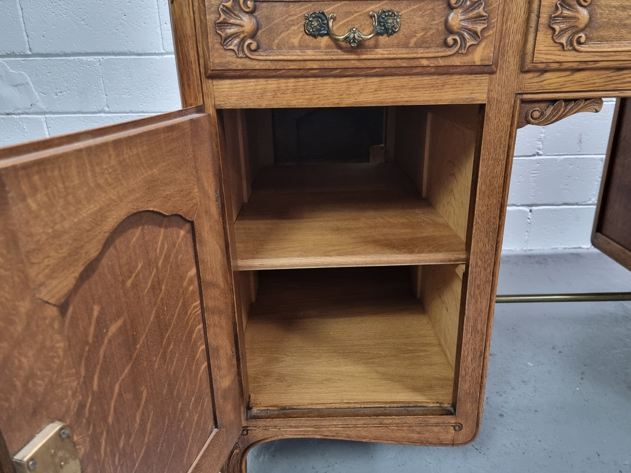Fabulous French oak carved partners desk with a lovely parquetry top. It has three drawers and two cupboards on one side and two cupboards on the other side with no functioning drawers. It is in good original detailed condition.