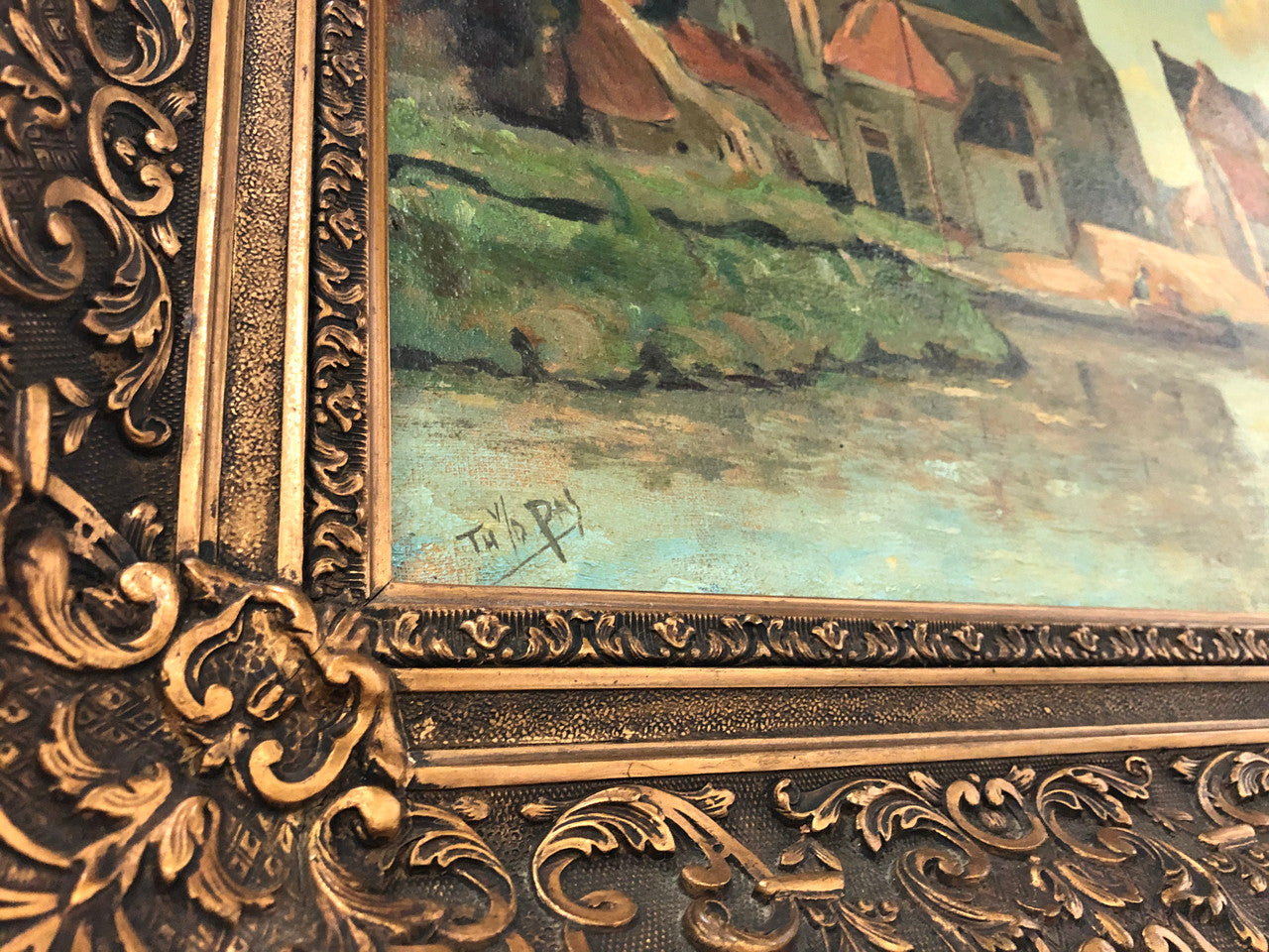 Sourced in France is this lovely oil on canvas town and river scene in a beautiful ornate frame. In good condition.