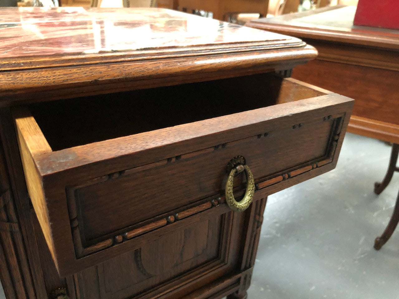 Lovely pair of French Oak Louis XVI style bedside cabinets with inset marble tops a drawer and a cupboard for storage. In good original detailed condition.