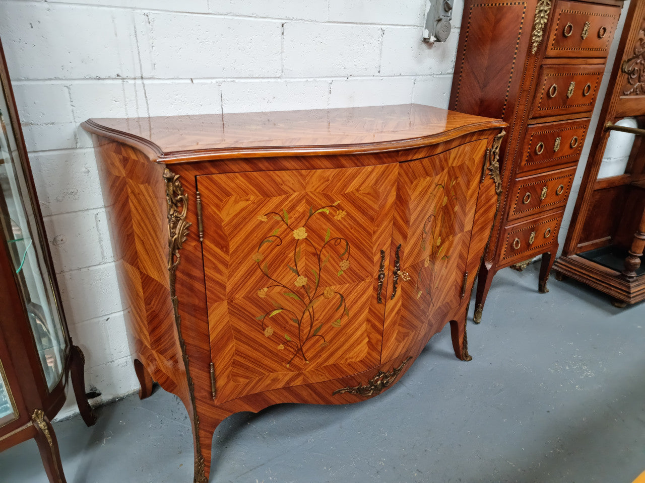 A high quality Louis XV style Kingwood marquetry inlay cabinet. Features extensive inlay inside the doors, and has beautiful ormolu mounts. In good original detailed condition.