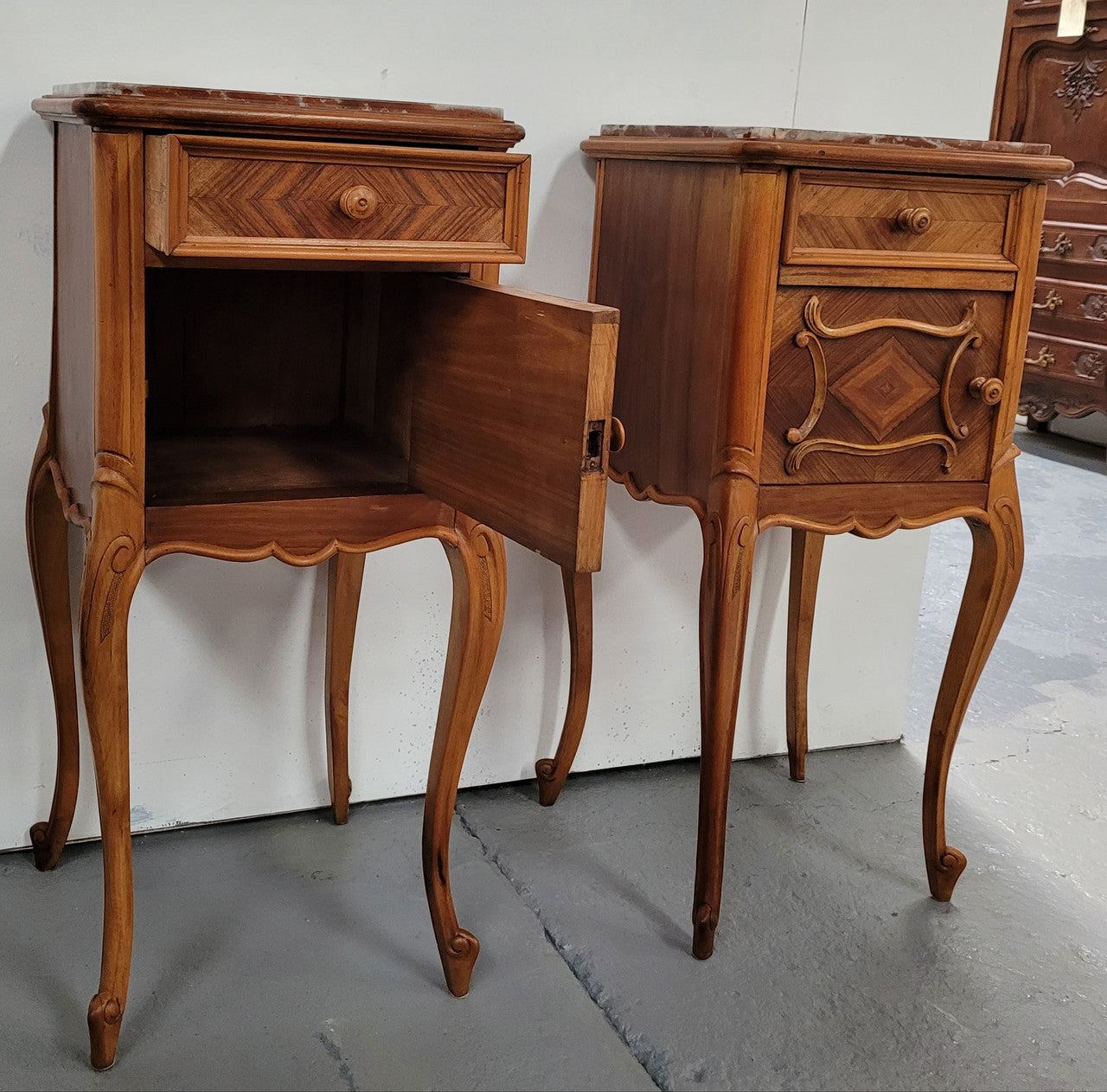 Pair French Walnut Louis XV style Bedside Cabinets with inset rouge carrera marble tops and parquetry inlay. Consisting of one drawer and one cupboard on very elegant legs. Circa: 1900's.