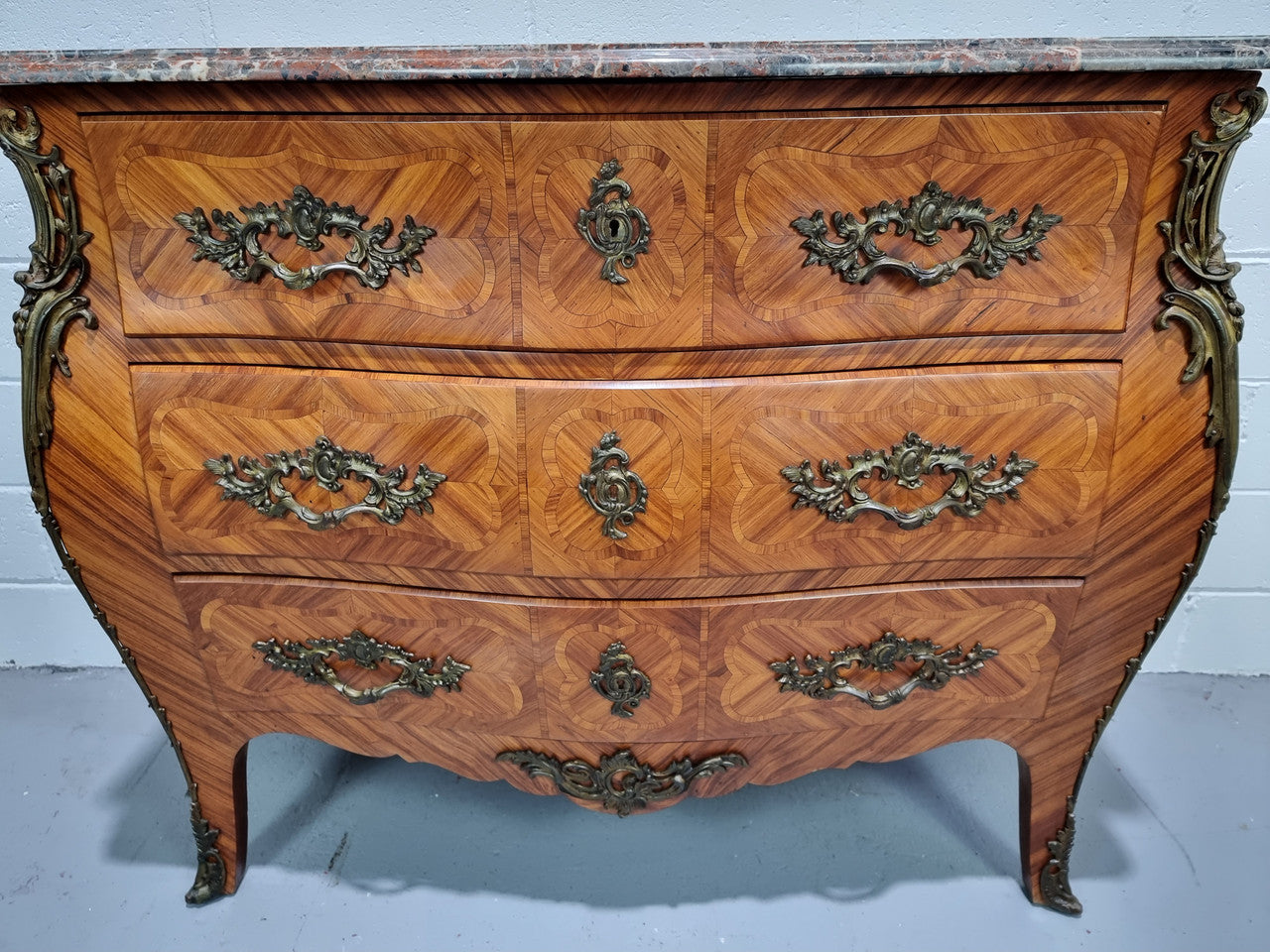 Attractive French marble top Louis XV style three drawer commode with decorative ormolu mounts. In good original detailed condition.