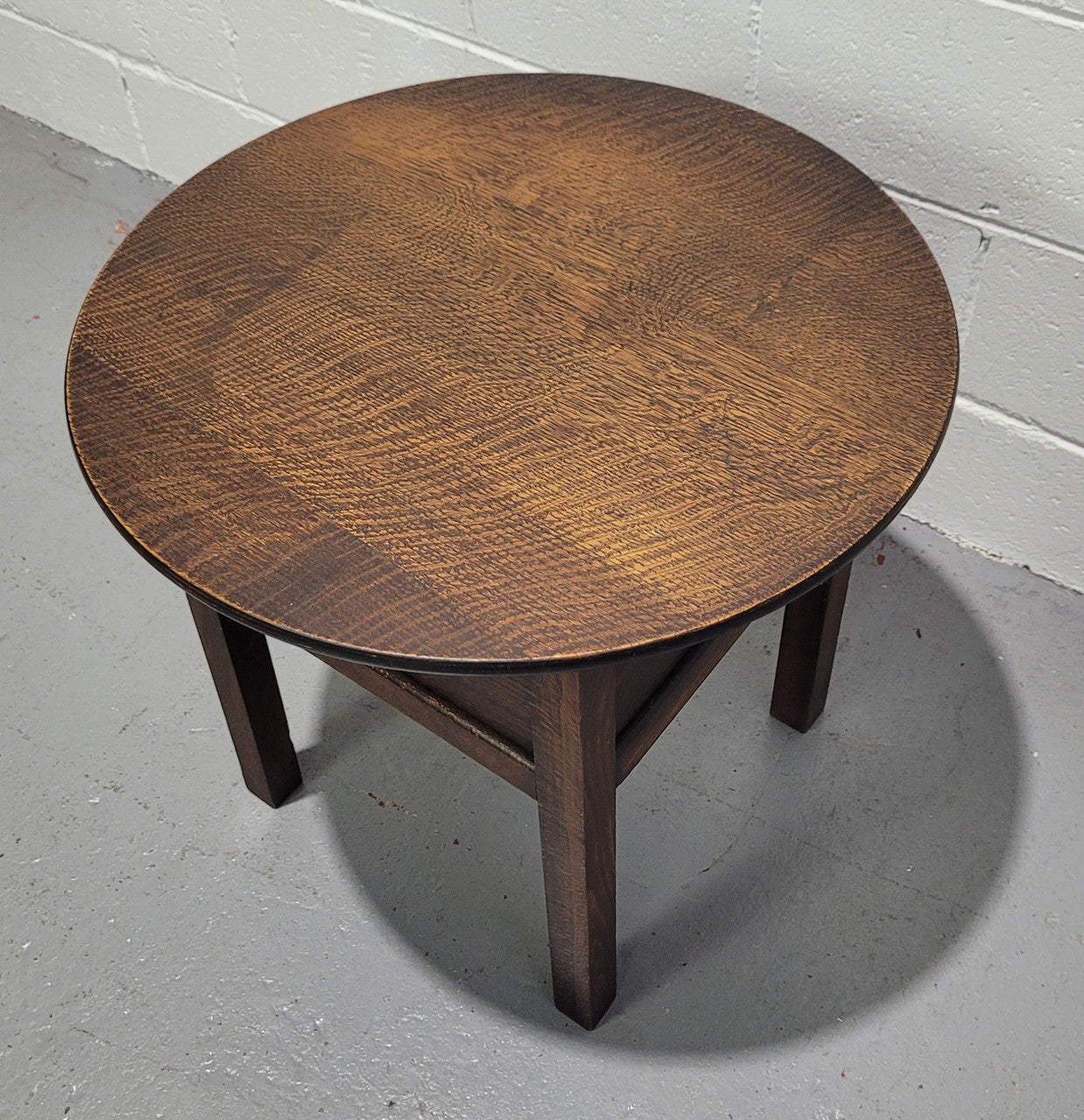 Fabulous round oak side table which also has a hidden sewing box underneath with lovely original blue satin lining and Includes pictured sewing items. It is in good original condition.