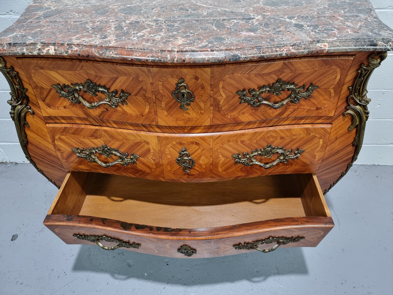 Attractive French marble top Louis XV style three drawer commode with decorative ormolu mounts. In good original detailed condition.