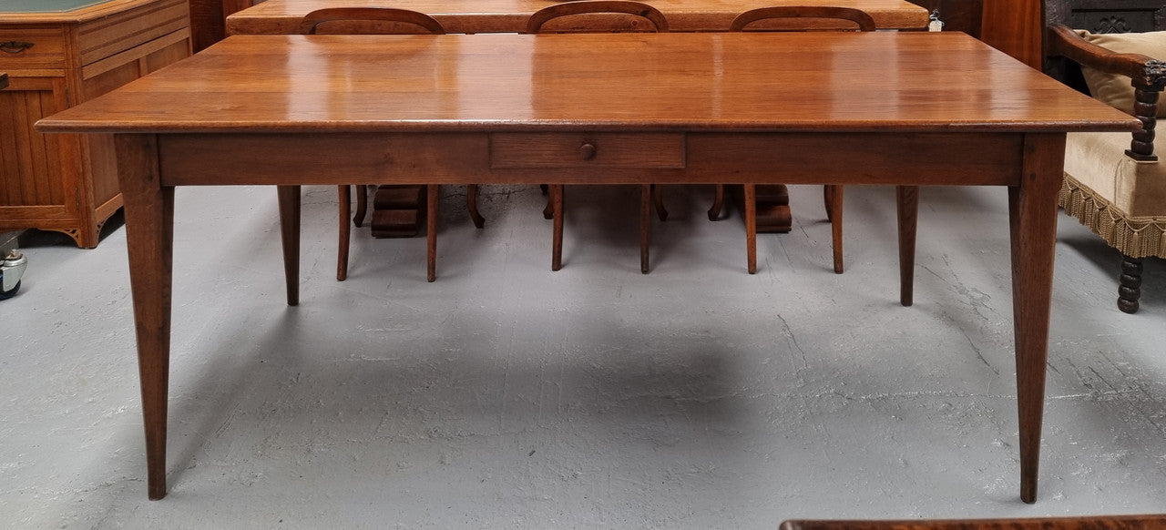 Antique French Oak Farmhouse table in fully restored condition. Features a single drawer and tapered legs.
