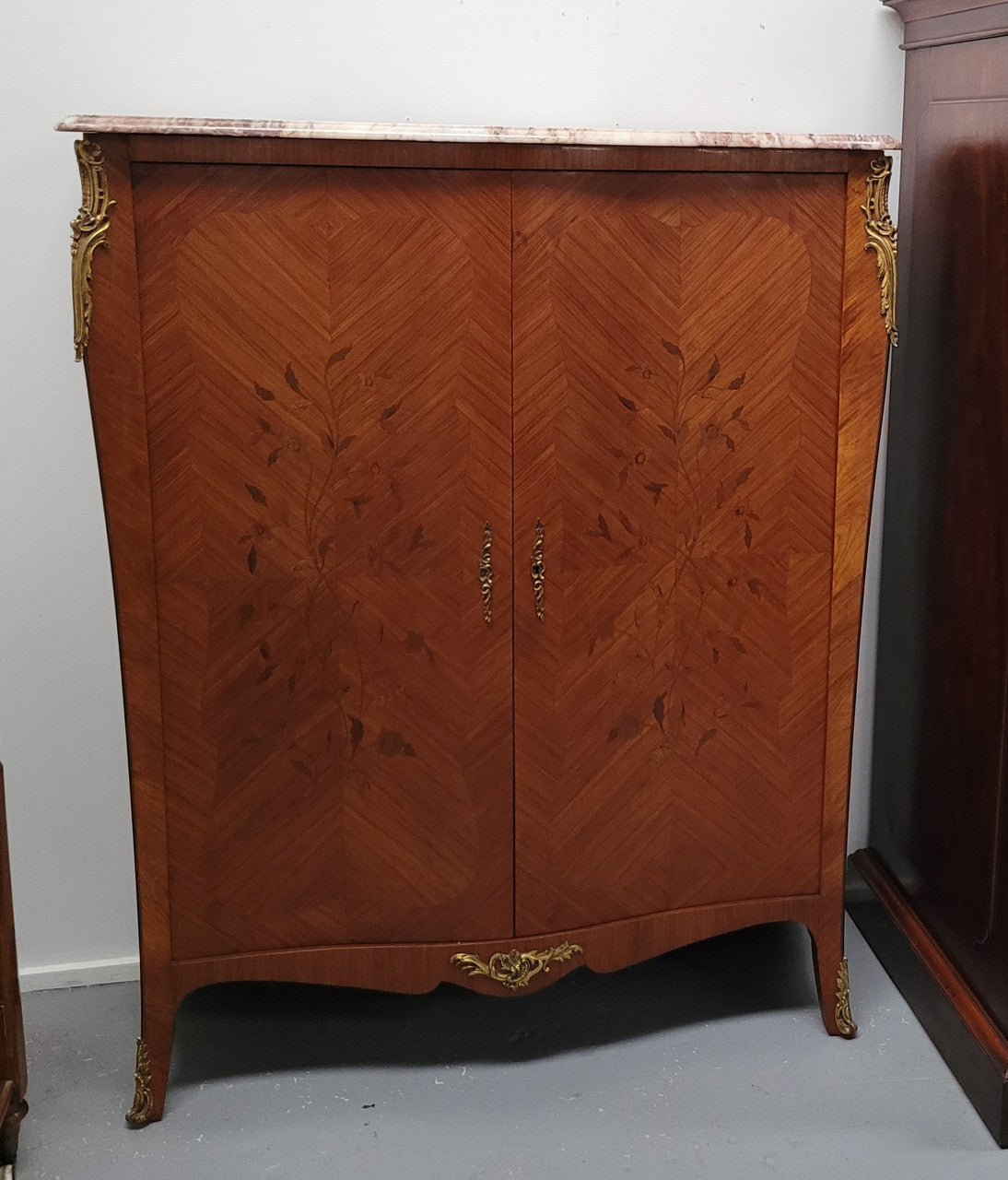 French Louis 15th style Kingwood marquetry inlaid two door cupboard with a beautiful marble top. It has three adjustable shelves and decorative ormolu trim. It has been sourced from France and is in good original detailed condition.