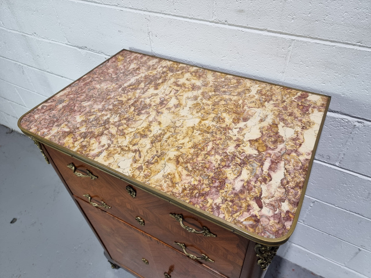 Lovely French Louis XV style Mahogany marquetry inlaid two door side cabinet. It has a beautiful coloured brass bound marble top in good original detailed condition.