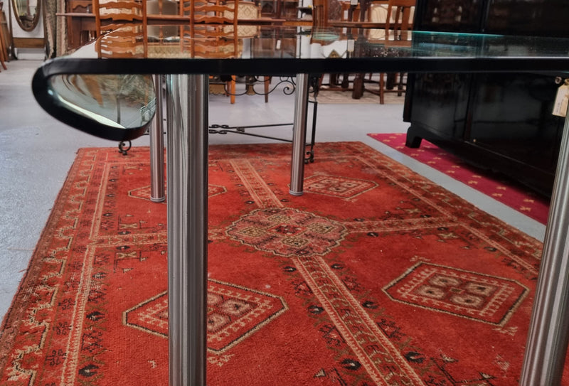 Striking and distinctive Vintage FIAM Italia Designer curved edge glass desk. FIAM was founded in 1973 by Vittorio Livio and has become synonymous with glass culture in Italy and the World. FIAM is still manufacturing today, in collaboration with various Designers, and has won numerous awards and is represented in various international museums. 
Condition: Evidence of use with minor scratches to the surface and a small chip that has been repaired. Overall, in very good condition with one repaired chip to t