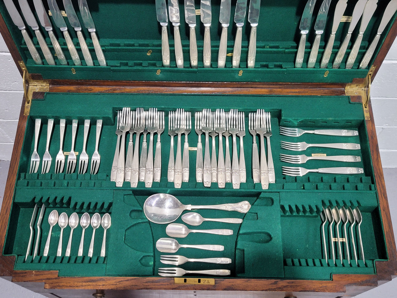 English Oak beautifully fitted cutlery table with a lift up top and drawer. Contains extensive silver plate part cutlery service by Elkington. In good original condition.