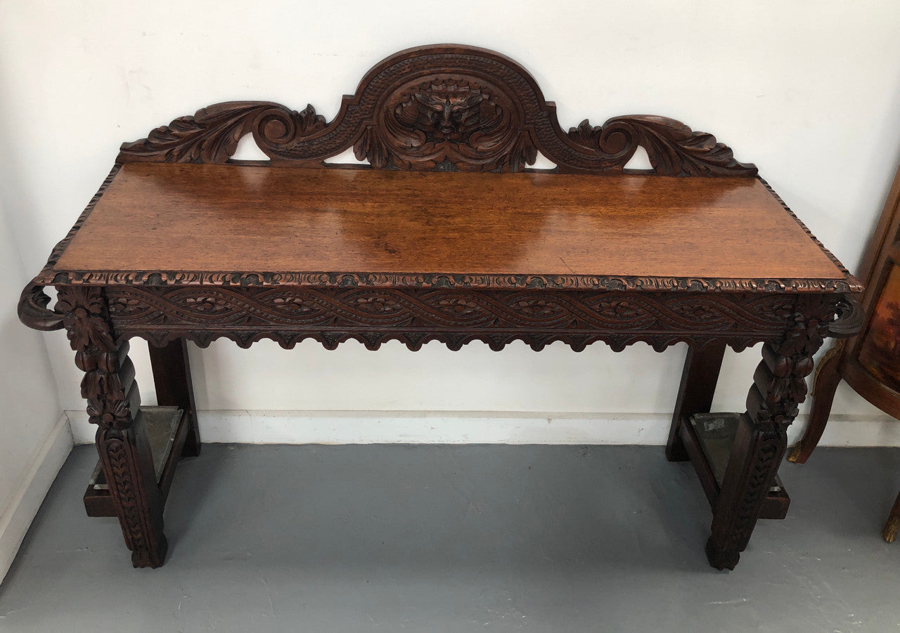 Superb 19th Century Gothic style hall/console table. It has umbrella and walking stick holders on both sides. In good original detailed condition.