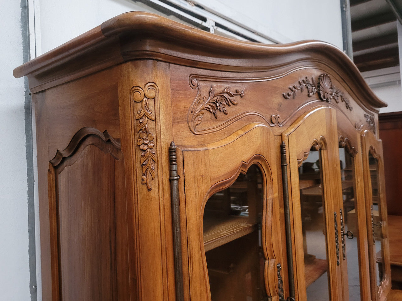 Magnificent French Walnut two-body four door display cabinet. Heaps of storage space with four glass doors at the top with shelves and four solid doors below also with shelving. It has been sourced from France and comes with a key for each door and all are lockable. In good original detailed condition.