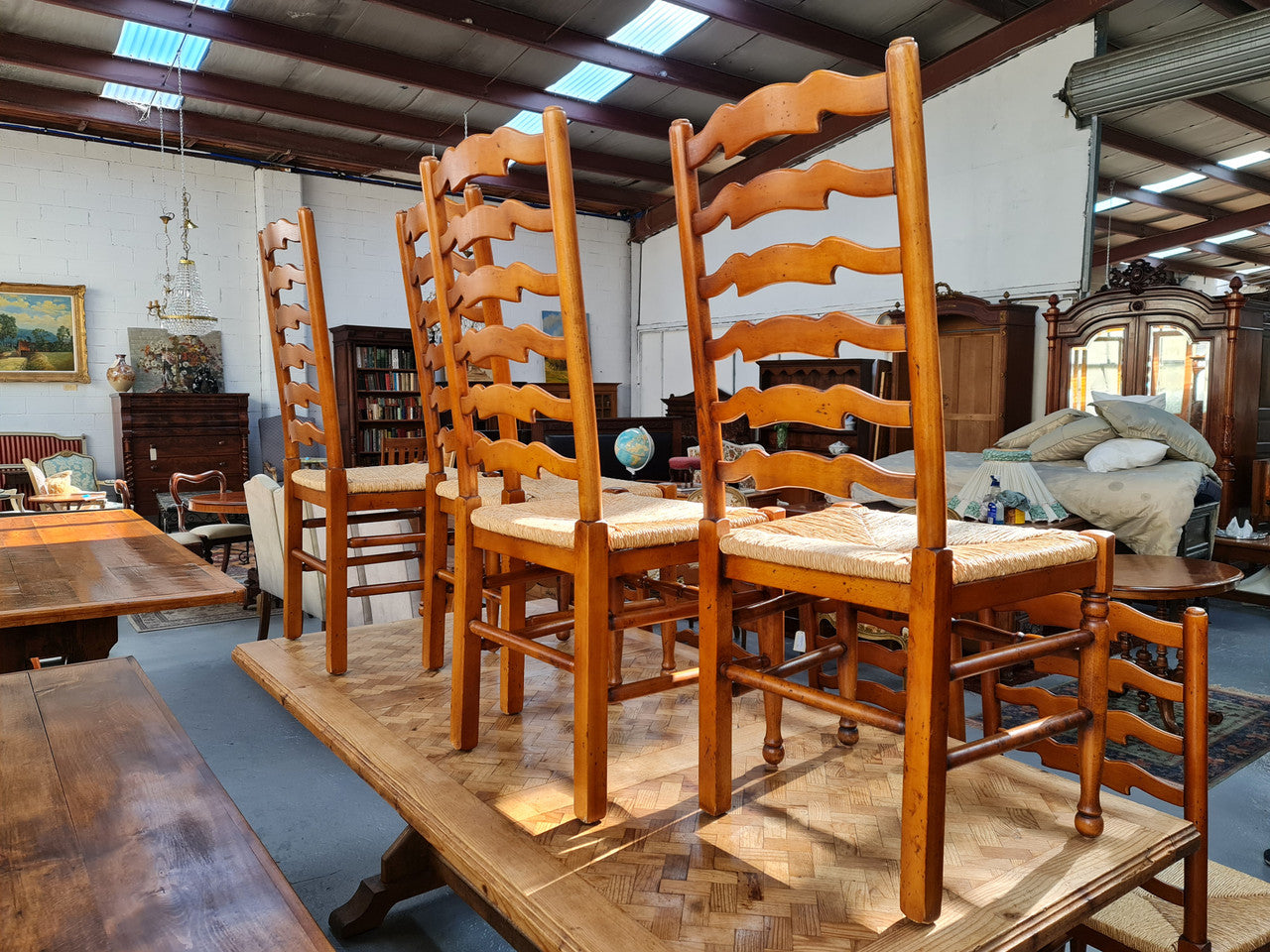 Charming set of eight Cherry Wood ladder back dining chairs. They are in good original detailed condition.