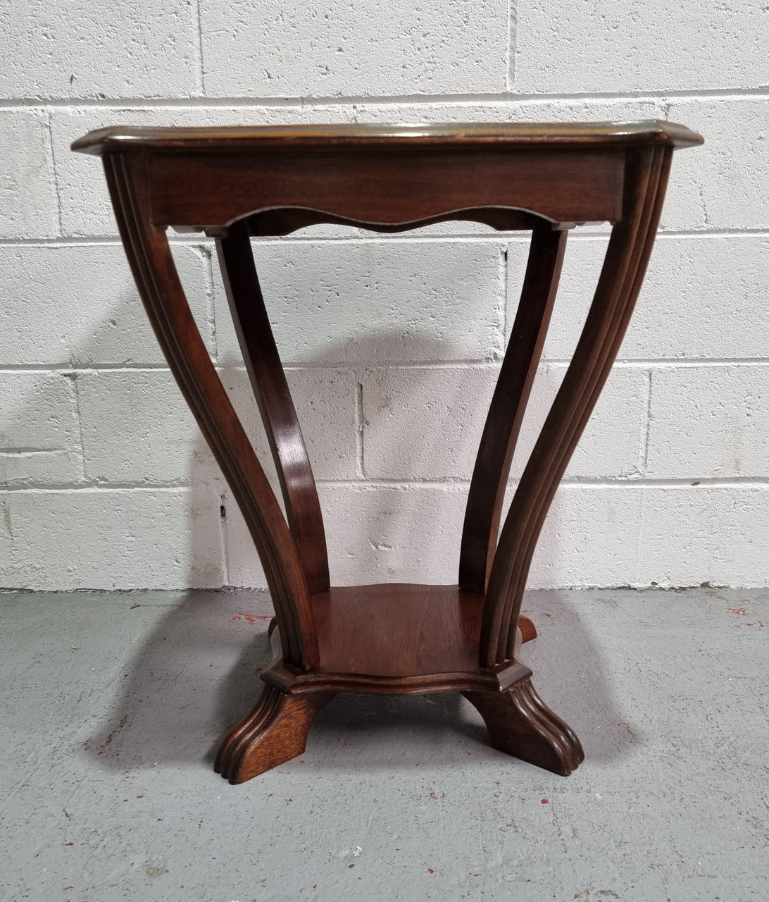 Charming Art Deco Square coffee table. Patterned veneer Top with legs shaping into a lower shelf. In good detailed condition.