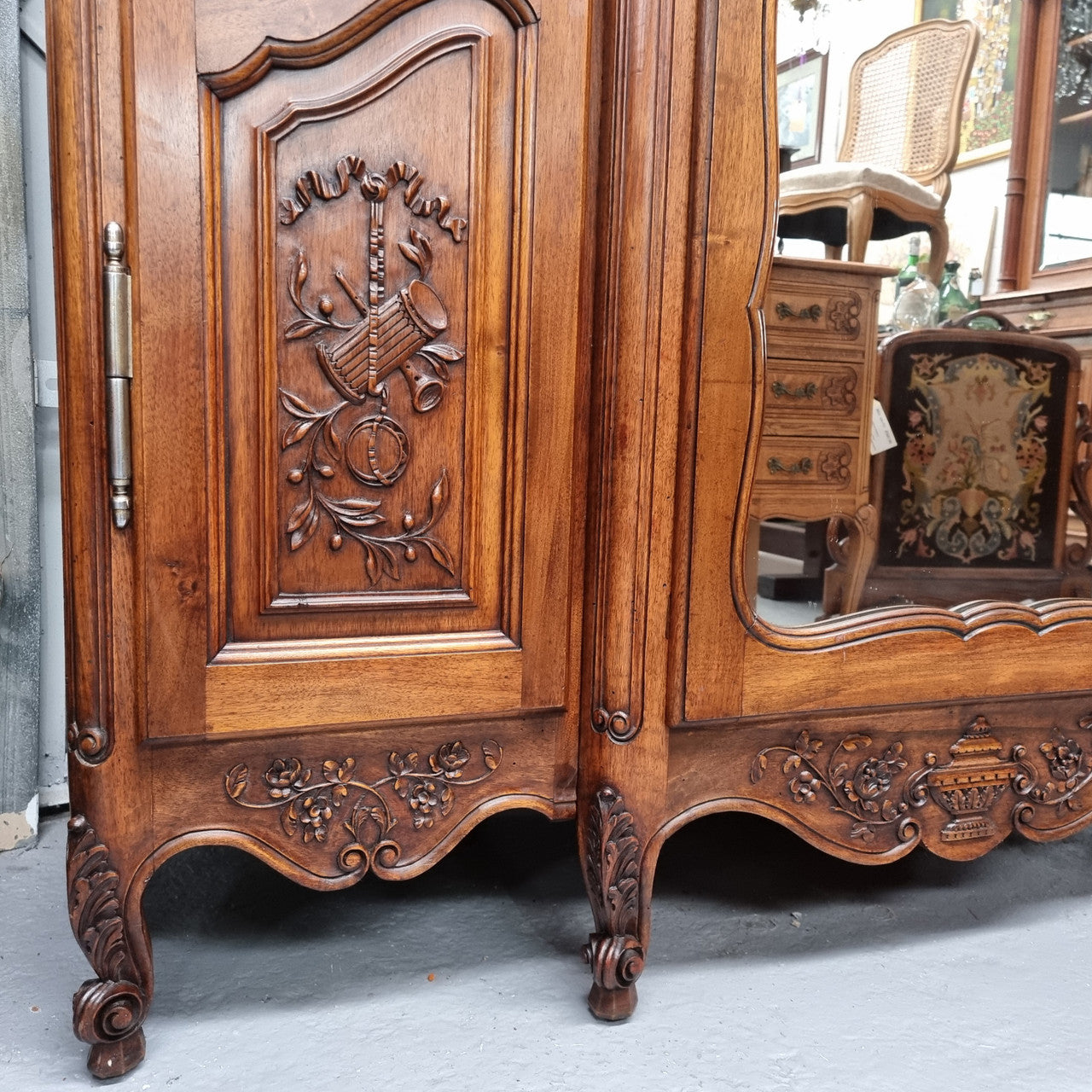 French Walnut Louis XV style three door armoire with 10 fully adjustable shelves in total spread over three sections, two drawers and a mirrored middle door. It has been sourced from France and in good original detailed condition.