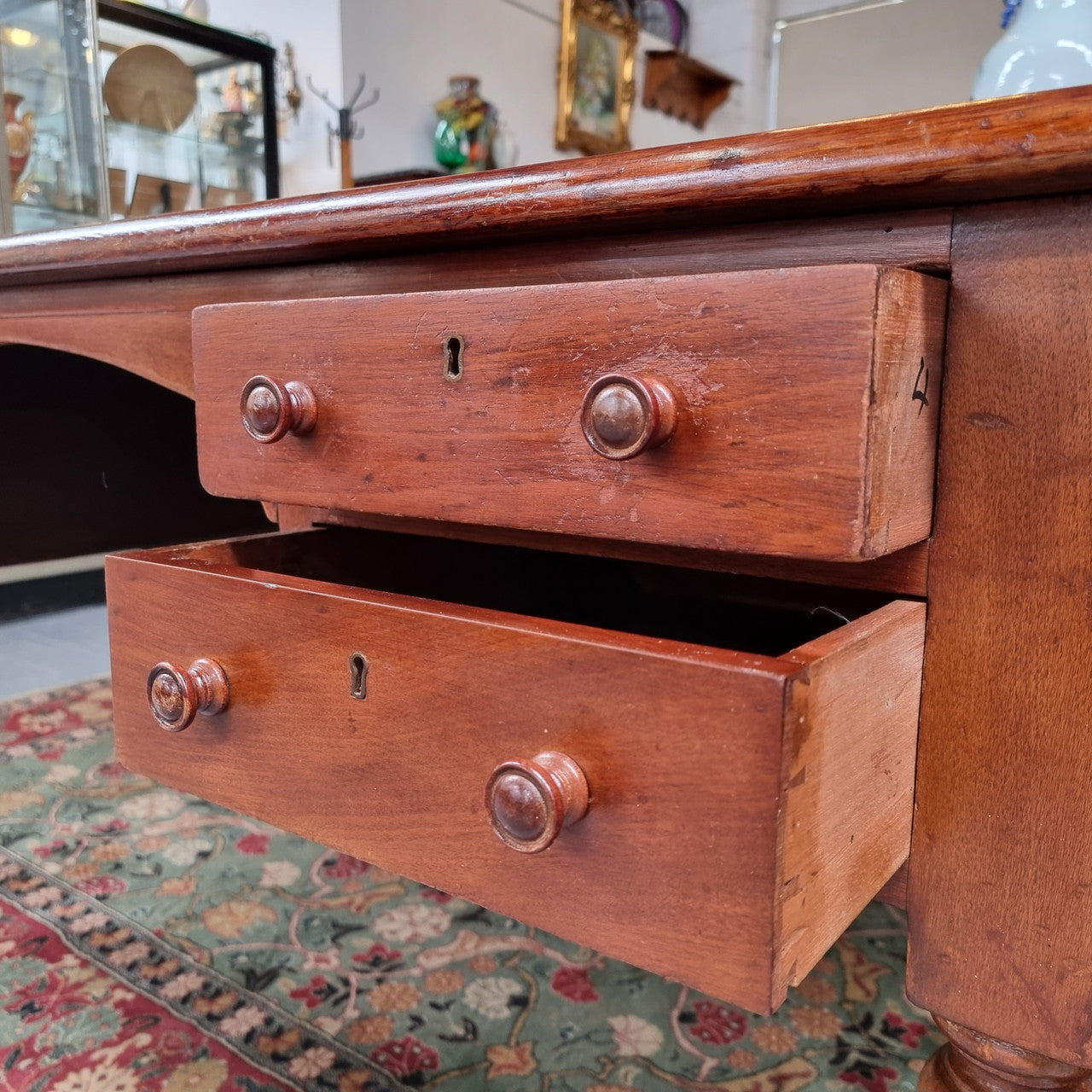 English Cedar full partners desk with attractive tooled leather top, four drawers either side and on caster wheels. In good original detailed condition.