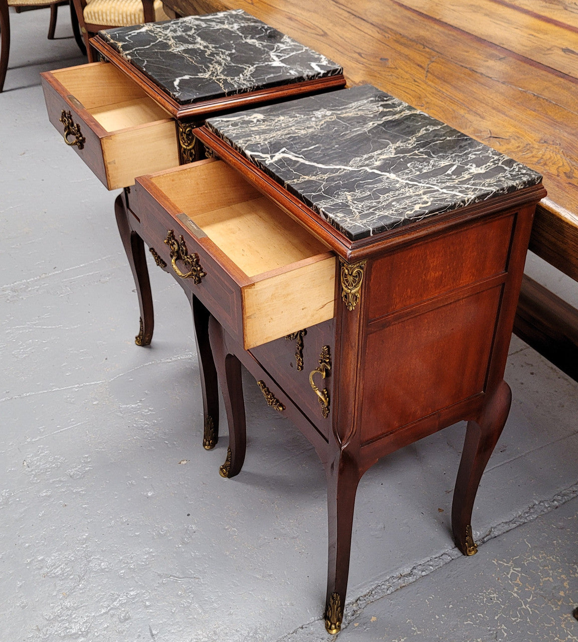 Appealing Louis XV style high quality bedside cabinets with black Portoro marble top and bronze mounts. They have been sourced from France and are in good original condition.