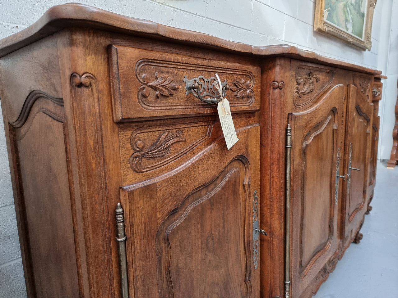 Parquetry top French oak Louis XV style sideboard with two draws and four cupboards. In good original detailed condition.