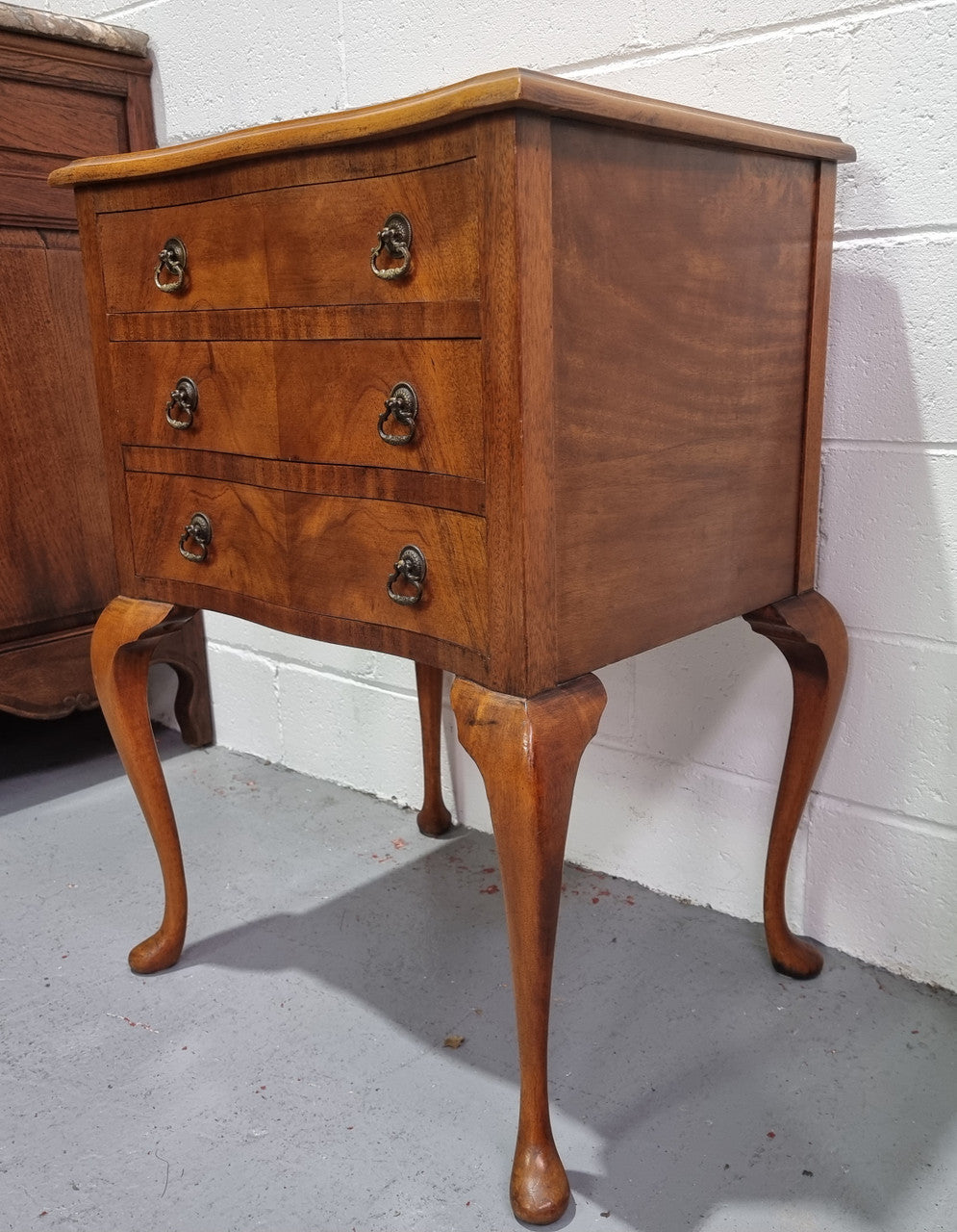 Antique Queen Anne style figured Walnut Bedside cabinet with 3 drawers. It is in good original detailed condition.