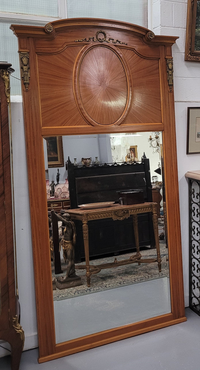 Stunning long Louis XV style satinwood Trumeau mirror decorated with Bronze ormolu mounts. It has its original bevelled mirror and it in good detailed condition. It has been sourced from France.