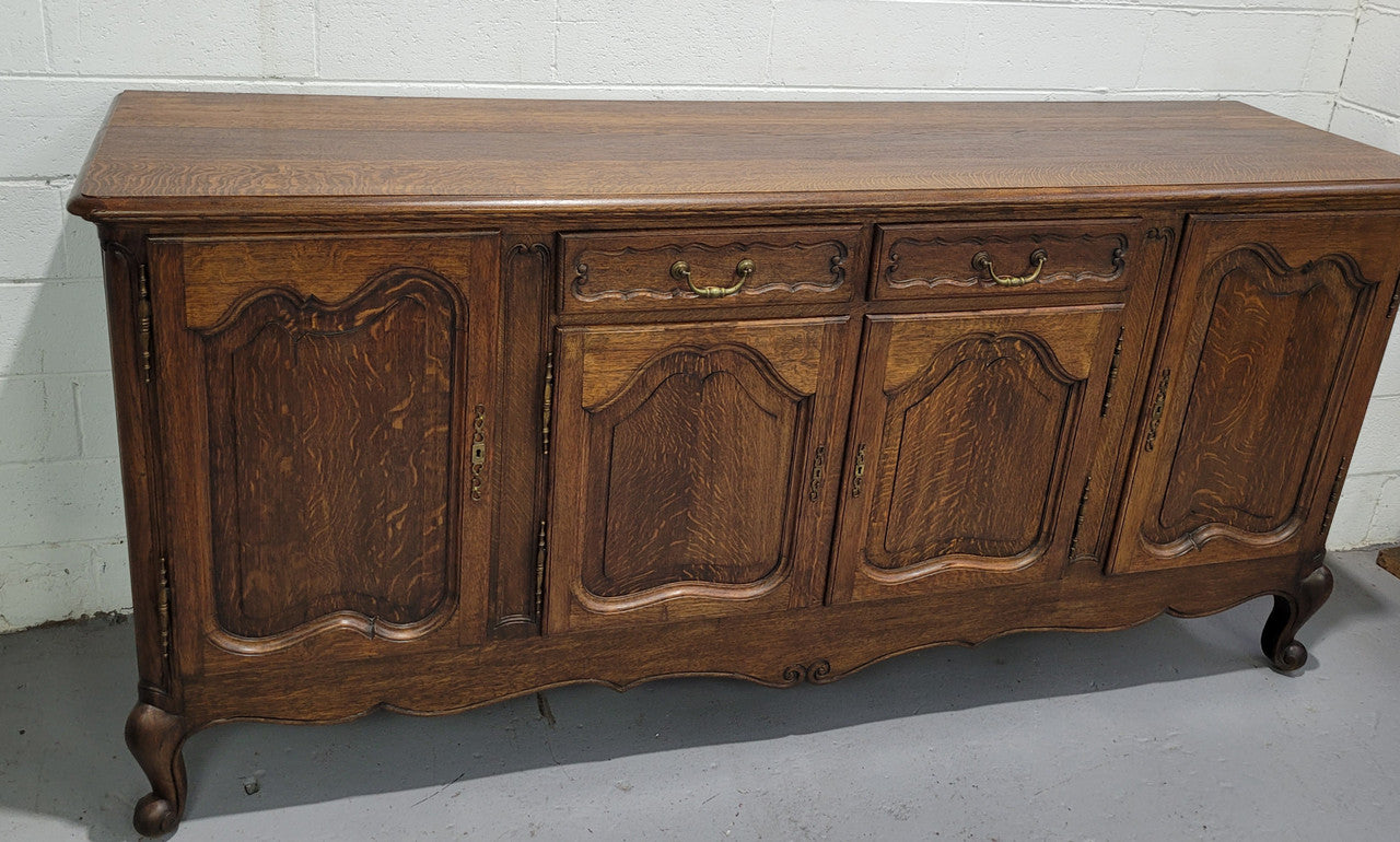Late 19th Century French carved Oak Louis XV style four drawer sideboard. Plenty of storage space with four cupboards and two drawers. It is in good original detailed condition with all locks functioning with keys.