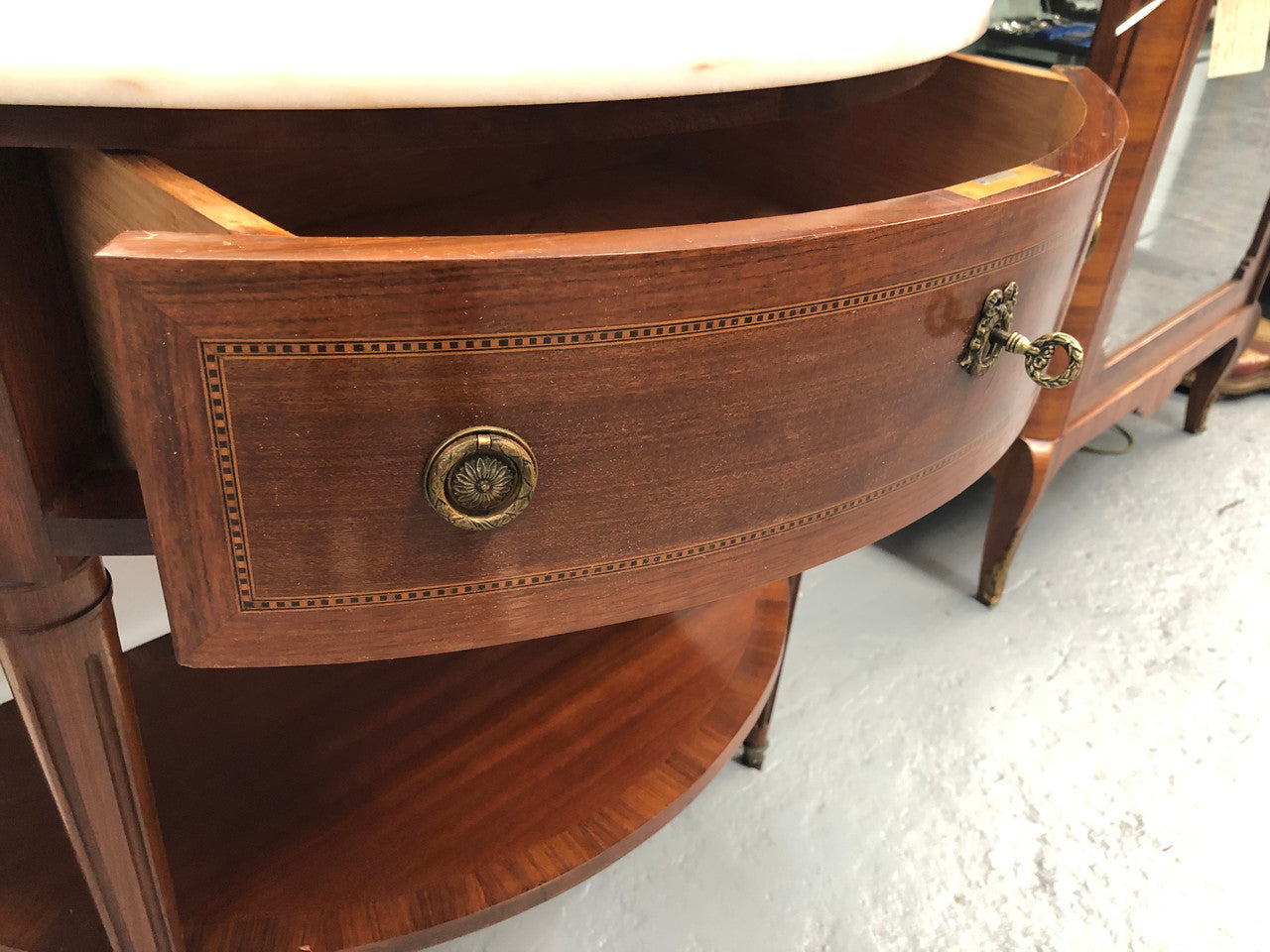 French marble top half round console table. It has beautiful marquetry inlay and ormolu mounts with a single drawer. In good original condition.