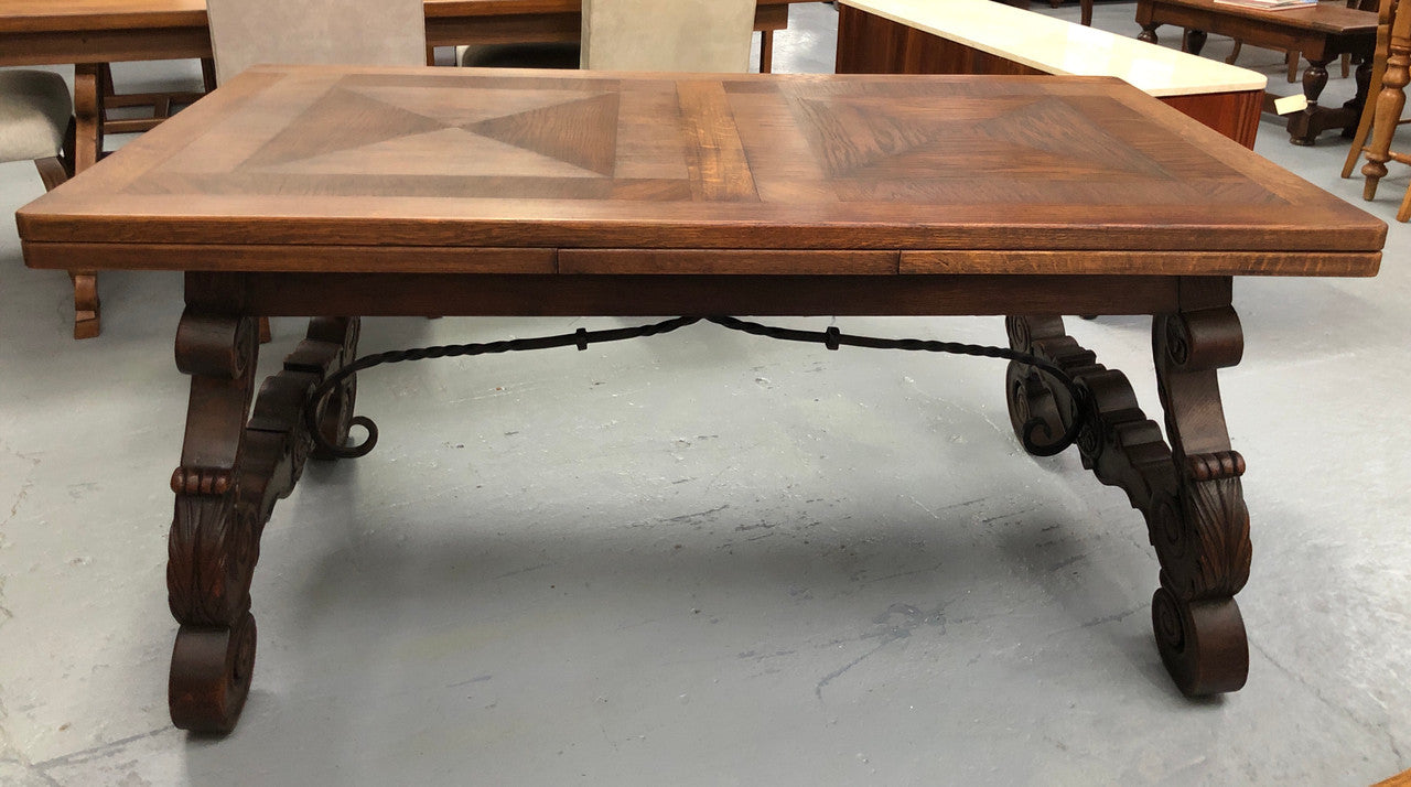 French Oak Renaissance style extension table with a lovely parquetry top and decorative carved and iron base in good original detailed condition.