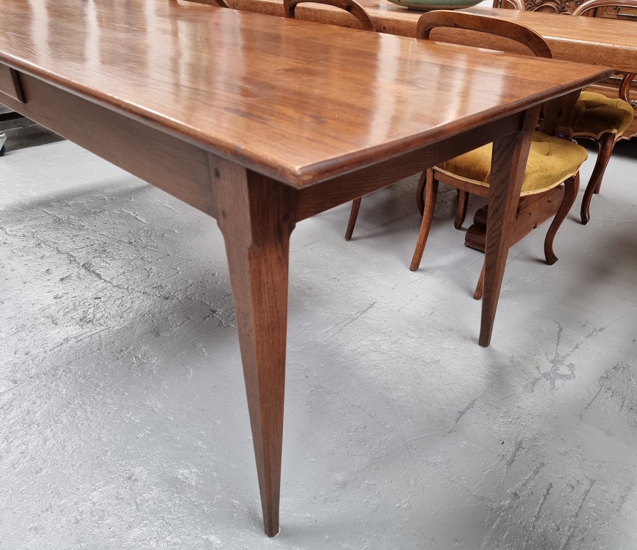 Antique French Oak Farmhouse table in fully restored condition. Features a single drawer and tapered legs.