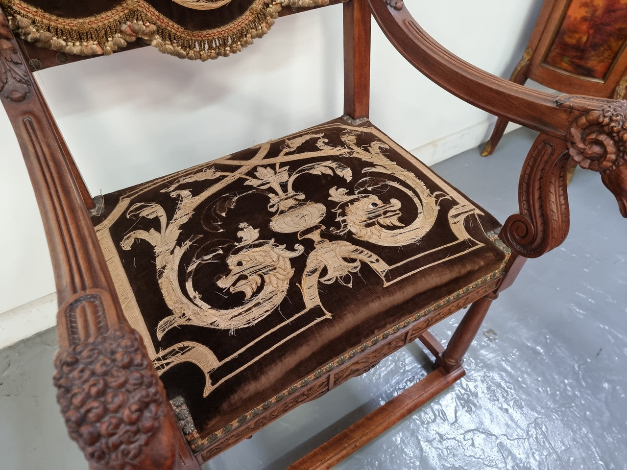 Beautifully carved Walnut Egyptian Revival armchair with amazing hand sewn Stumpwork embroidery coverings. In good original detailed condition.