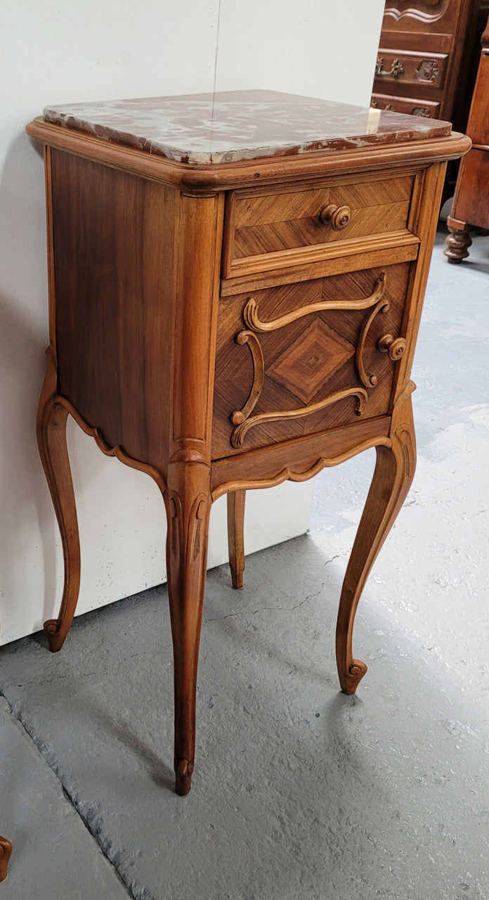 Pair French Walnut Louis XV style Bedside Cabinets with inset rouge carrera marble tops and parquetry inlay. Consisting of one drawer and one cupboard on very elegant legs. Circa: 1900's.